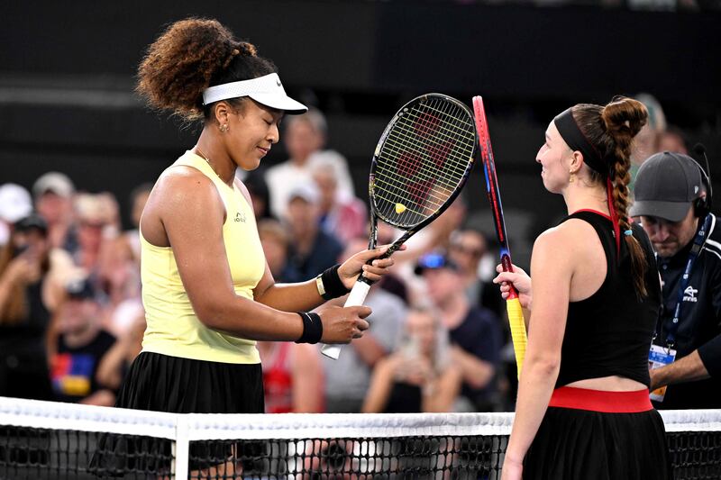 Naomi Osaka bumps racquets with Tamara Korpatsch after victory in their match at the Brisbane International. AFP