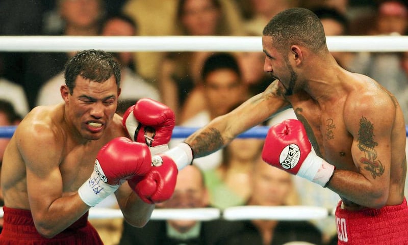 LAS VEGAS - MAY 7:  Diego Corrales lands a right on the face of Jose Luis Castillo during their World Lightweight Unification bout on May 7, 2005 at The Mandalay Bay in Las Vegas, Nevada. Corrales won the fight after the referee stopped the fight in the tenth round.  (Photo by Nick Laham/Getty Images)