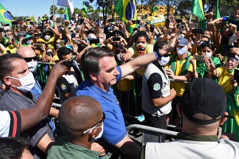 Brazilian President Jair Bolsonaro greets supporters during a demonstration in Brasilia.  AFP