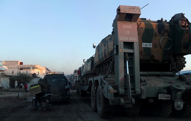 Turkish military vehicles enter the Bal al-Halwa crossing at the Syrian-Turkish border, in Idlib governorate, Syria. REUTERS