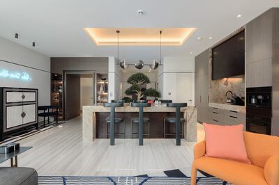 A modern Italian marble kitchen island serves as a built-in dining area. Photo: Luxhabitat Sotheby's International Realty