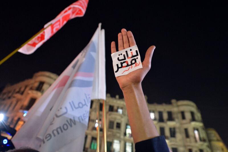 An Egyptian protester holds up his hand with an Arabic slogan reading 'Egyptian girls are a red line' at a demonstration in Cairo. AFP