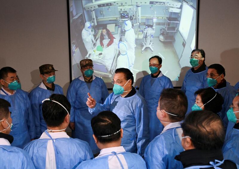 Chinese Premier Li Keqiang wearing a mask and protective suit speaks to medical workers as he visits the Jinyintan hospital where the patients of the new coronavirus are being treated following the outbreak, in Wuhan, Hubei province, China. Reuters