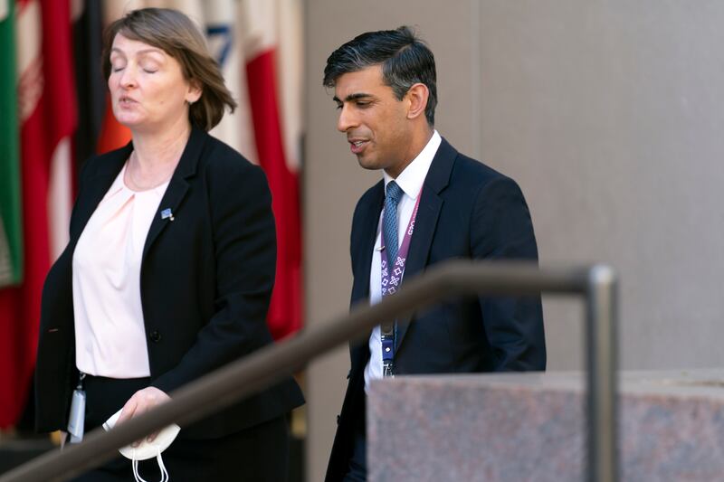 Britain's Chancellor of the Exchequer Rishi Sunak walks outside of the International Monetary Fund building in Washington. AP Photo