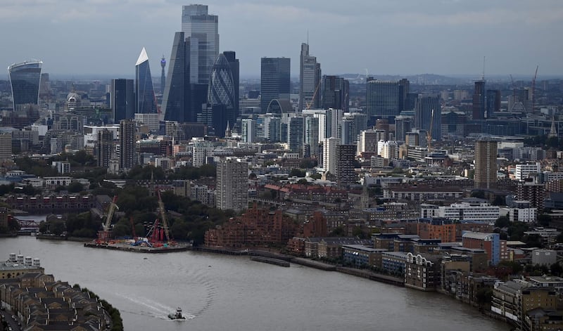 The skyline, including the office buildings of the City of London, is seen beyond the River Thames in London, England on September 02, 2020. / AFP / DANIEL LEAL-OLIVAS
