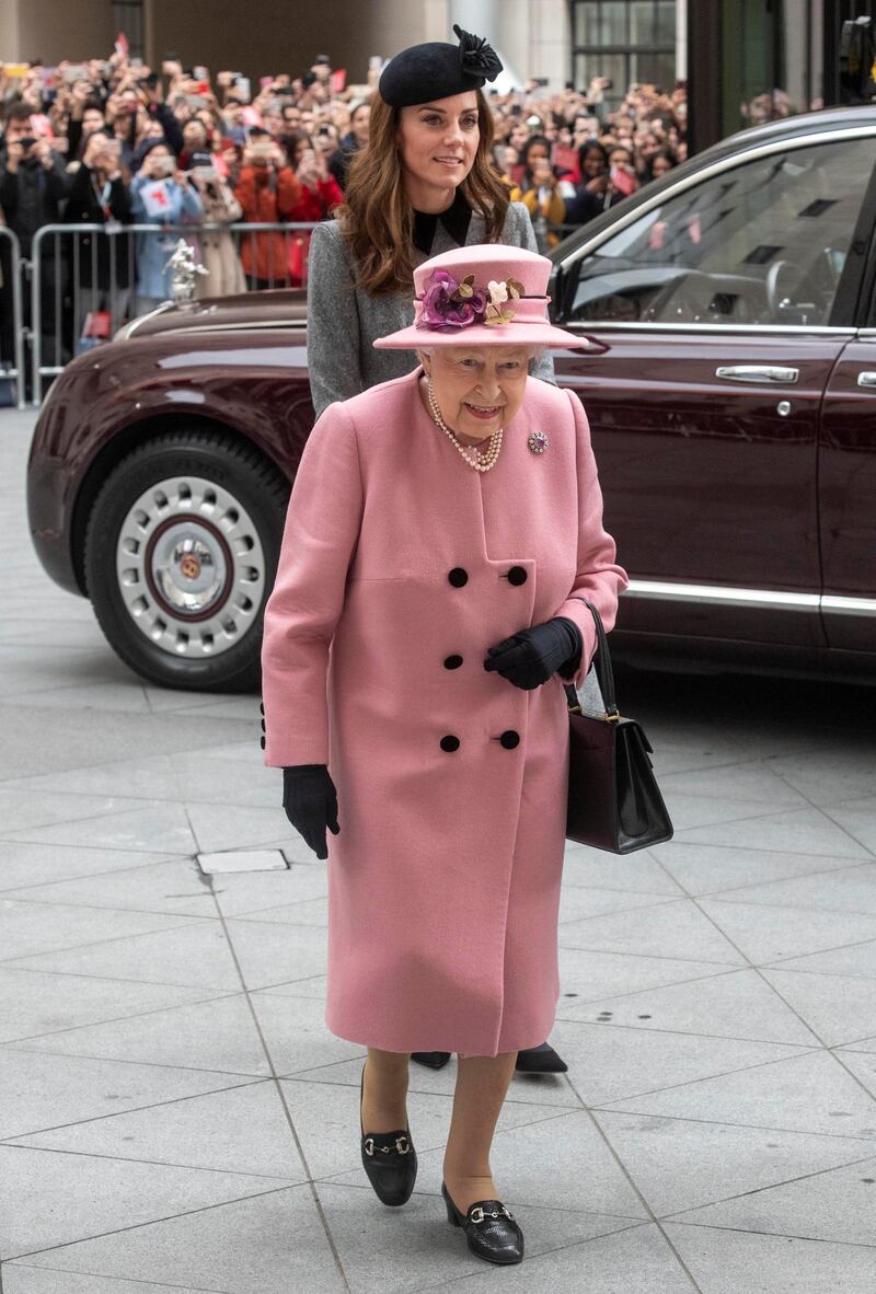 For the joint visit, Queen Elizabeth II wears a Stewart Parvin Old Rose cashmere coat, a Rachel Trevor-Morgan hat and Cornelia James gloves. Reuters
