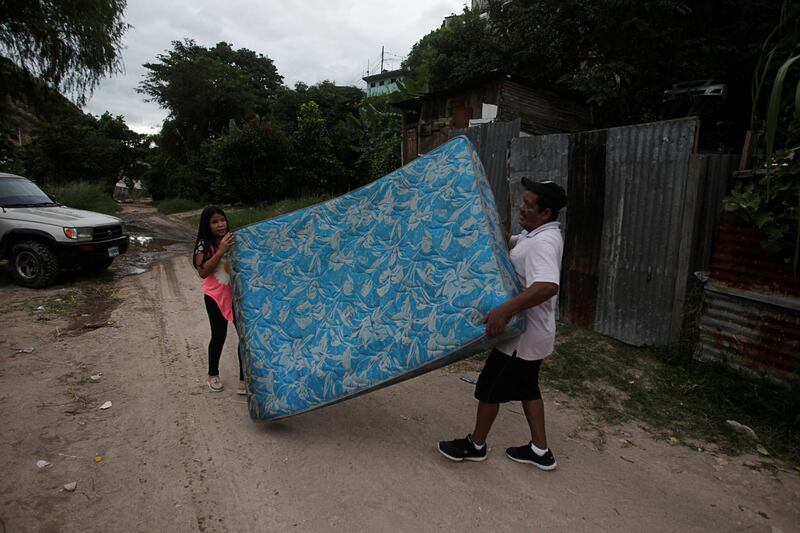 Residents carry a mattress as they evacuate their house in anticipation of heavy rains as Hurricane Iota approaches, in Tegucigalpa, Honduras. Reuters