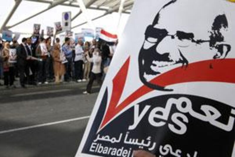 Supporters of Mohamed ElBaradei prepare to give him a hero's welcome at the Cairo airport yesterday.