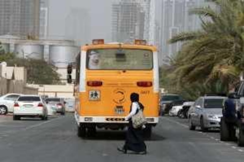 DUBAI, UNITED ARAB EMIRATES - MARCH 02:  A bus drops school girls off in the residential part of the Al Quoz district of Dubai on March 02, 2009.  (Randi Sokoloff / The National)  For House & Home story by Stella Rosat. *** Local Caption ***  RS017-030209-AlQuoz.jpg
