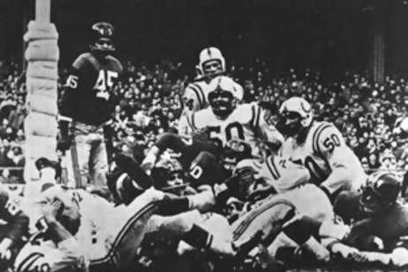 Baltimore Colts' full-back Alan Ameche, on ground at left, lies in the end zone at the Yankee Stadium after his overtime touchdown defeated the New York Giants, 23-17, 50 years ago.