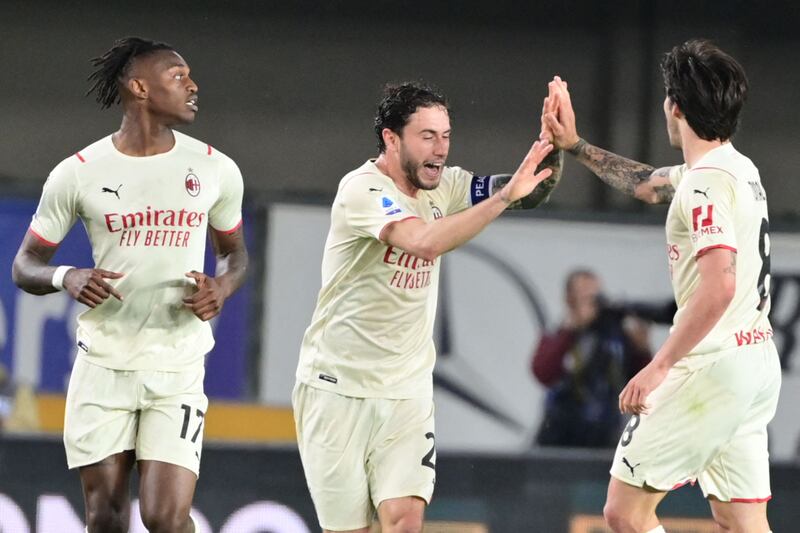 AC Milan's Rafael Leao, left, and Davide Calabria celebrate with goalscorer Sandro Tonali after the latter scored against Hellas Verona at the Marcantonio-Bentegodi Stadium in Verona.  AFP