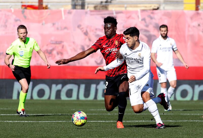 Marco Asensio of Real battles with Mallorca's Iddrisu Mohamed Baba. AFP