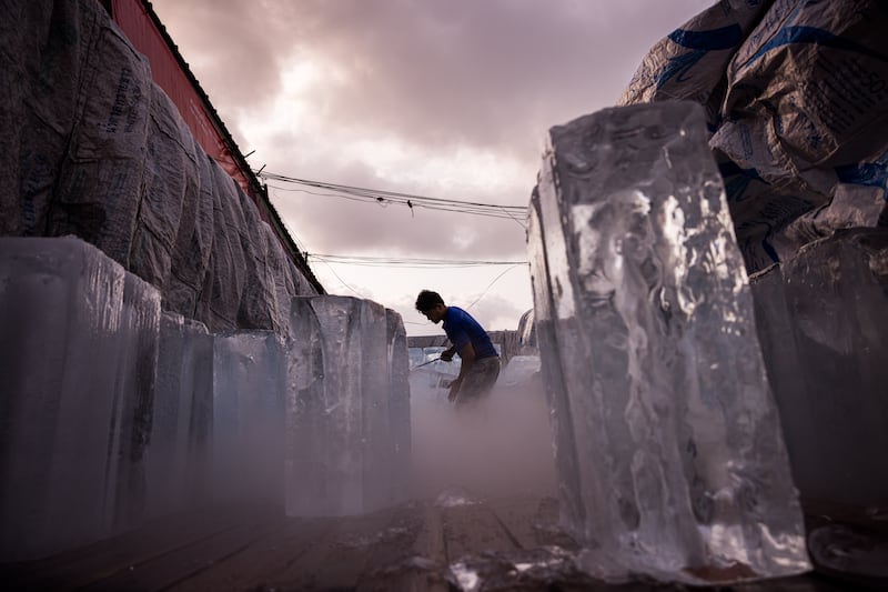A man unloads blocks of ice from a lorry during a heatwave in Bangkok. Thailand has been bracing for hotter-than-normal days due to the El Nino weather pattern. Bloomberg