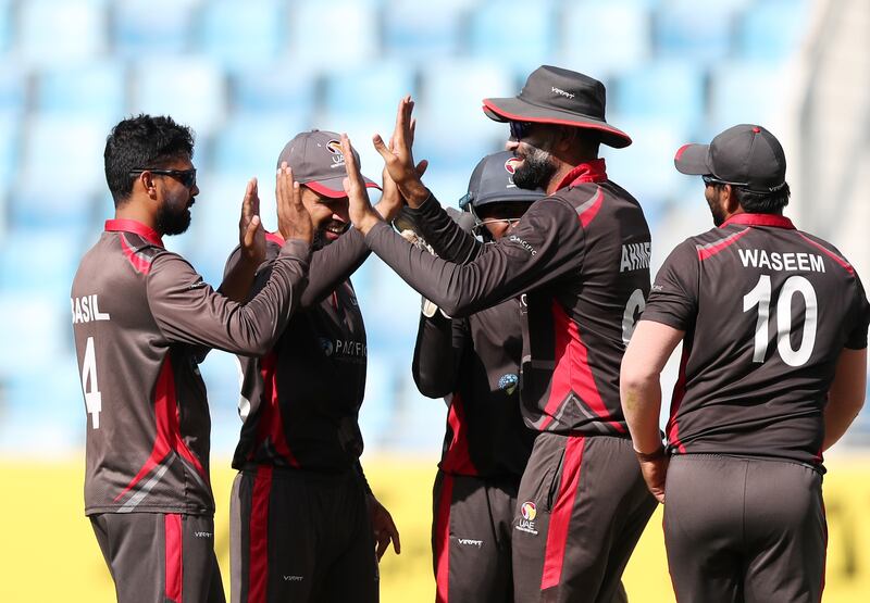 UAE's Basil Hameed takes the wicket of Nepal's Kamal Airee.