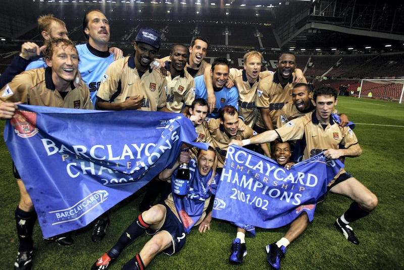 MANCHESTER - MAY 8:  Arsenal players celebrate winning the league title after the FA Barclaycard Premiership match between Manchester United and Arsenal played at Old Trafford, in Manchester, England on May 8, 2002. Arsenal won the match 1-0 to clinch the league title. DIGITAL IMAGE. (Photo by Alex Livesey/Getty Images)