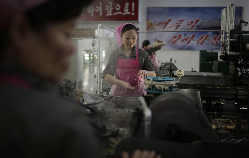 A North Korean worker boils silkworm cocoons at the Kim Jong-suk silk mill in Pyongyang, North Korea. Wong Maye-E/AP Photo
