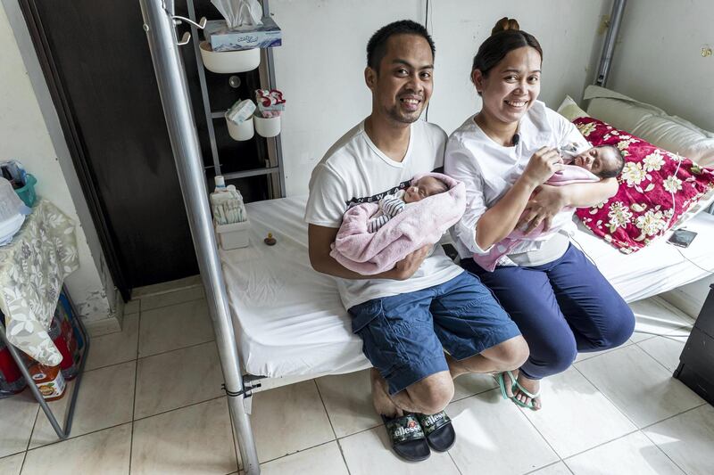 DUBAI, UNITED ARAB EMIRATES. 16 MARCH 2021. Parents John and Monica Pentio Tubo who have recently given birth to twins have been re-united with their daughters after a benefactor came foward and paid their outstanding hospital bills. The couple is shown here in the small room they share with with other people where they have made arrangements for the arrival of the twins. (Photo: Antonie Robertson/The National) Journalist: Patrick Ryan. Section: National.
