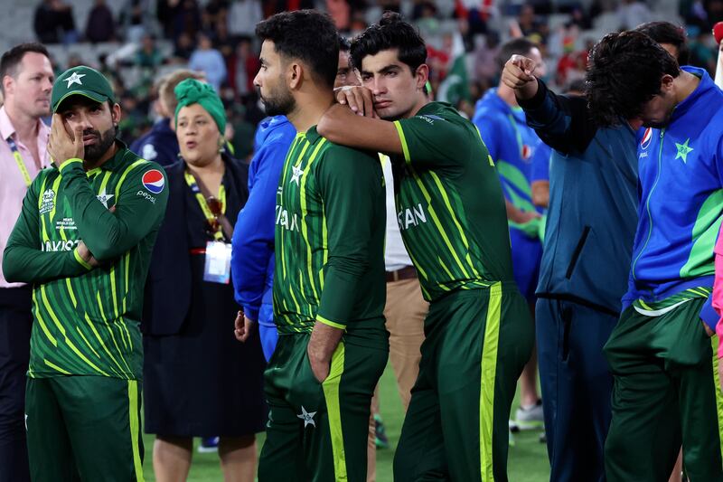 Pakistan players wait for presentation ceremonies after losing to England. AP 