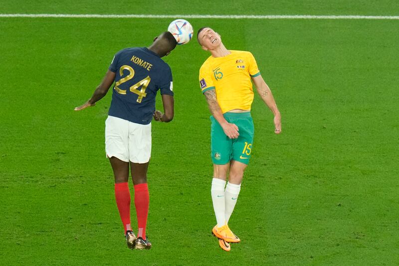 France's Ibrahima Konate, left, and Australia's Mitchell Duke jump for the ball. AP 