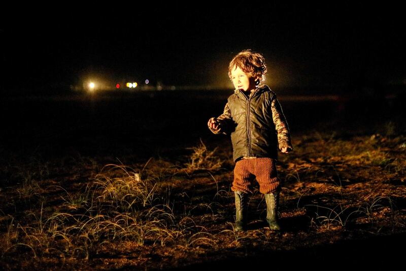 A child who was evacuated from the Islamic State (IS) group's embattled holdout of Baghouz, walks toward a zone held by the US-backed Syrian Democratic Forces (SDF).   AFP