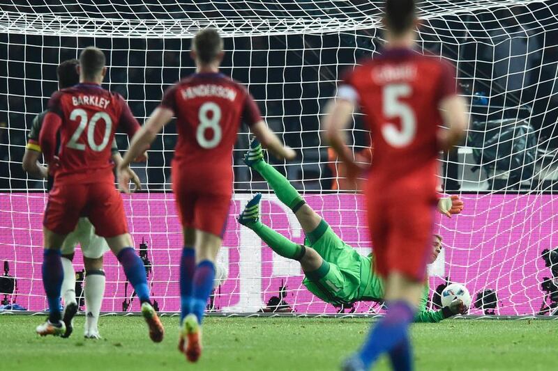 Germany’s goalkeeper Manuel Neuer fails to save the ball for the 2-2 goal during the friendly football match Germany v England at the Olympic Stadium in Berlin on March 26, 2016. / AFP / ODD ANDERSEN