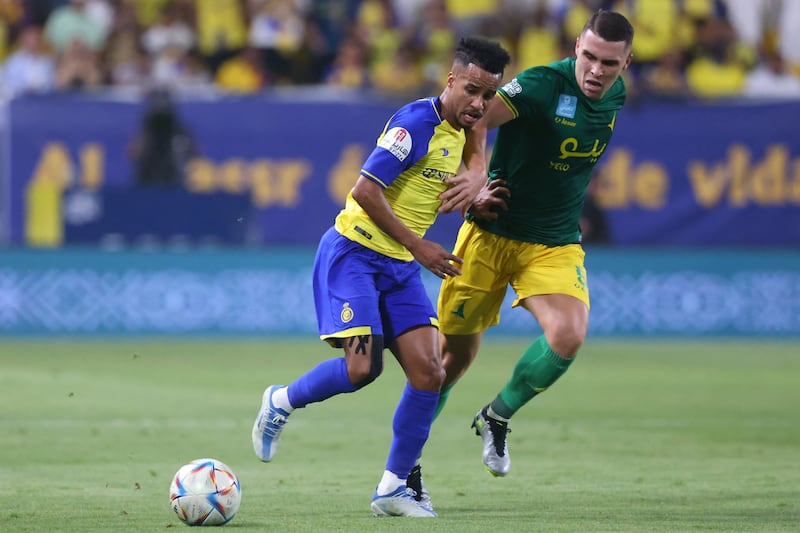 Nassr midfielder Abdulrahman Ghareeb vies for the ball with Khaleej defender Pedro Amaral.