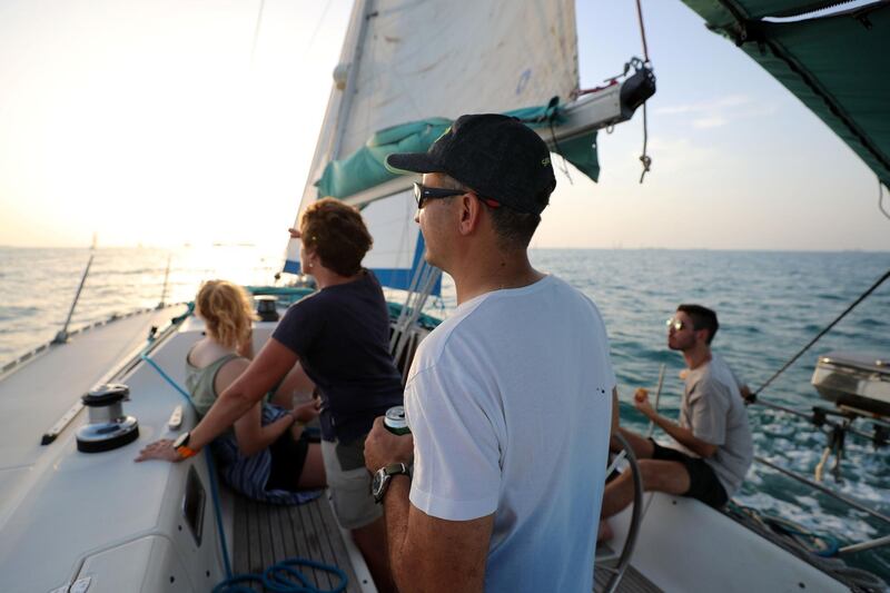 Dubai, United Arab Emirates - May 14, 2019: Matt Stone (R), Devrim Anadol, Marie Byrne and Maisie Letten (L) take part in the Dubai offshore sailing club pursuit race. Tuesday the 14th of May 2019. Dubai. Chris Whiteoak / The National
