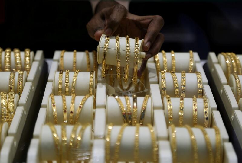 FILE PHOTO: A salesman arranges gold bangles inside a jewellery showroom on the occasion of Akshaya Tritiya, a major gold buying festival, in Mumbai, India, May 7, 2019. REUTERS/Francis Mascarenhas - RC1FAD8B8610/File Photo