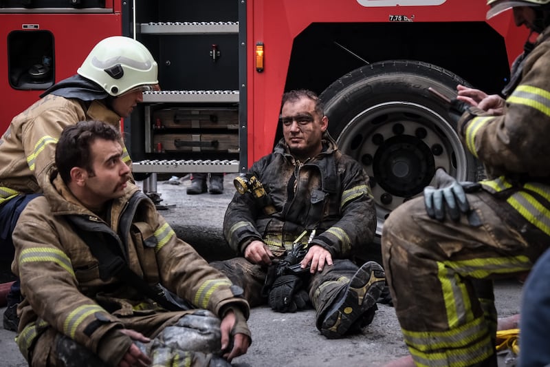 Firefighters rest after battling a fire that broke out at the Masquerade nightclub in Istanbul, Turkey. Getty Images