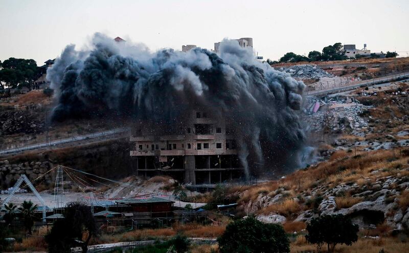 A Palestinian building is demolished by Israel in the the Palestinian village of Sur Baher in East Jerusalem.  AFP