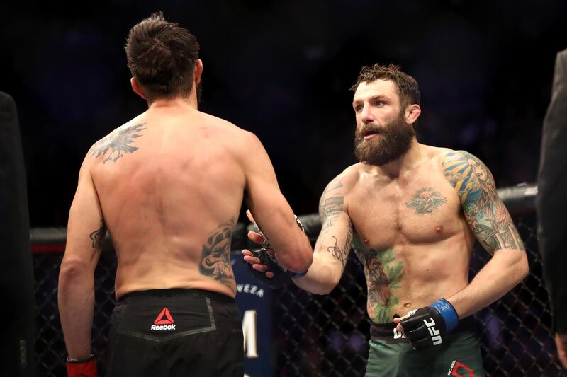 INGLEWOOD, CA - DECEMBER 29: Carlos Condit (left) congratulates Michael Chiesa (right) after he was defeated during a Welterweight bout during the UFC 232 event inside The Forum on December 29, 2018 in Inglewood, California.   Sean M. Haffey/Getty Images/AFP