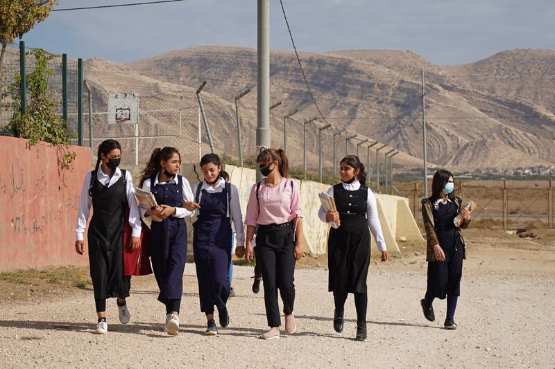 Girls walk to class on the first day of school in a Yazidi displacement camp in the Sharya area, 15 kilometres from the city of Dohuk in Iraqi Kurdistan. AFP