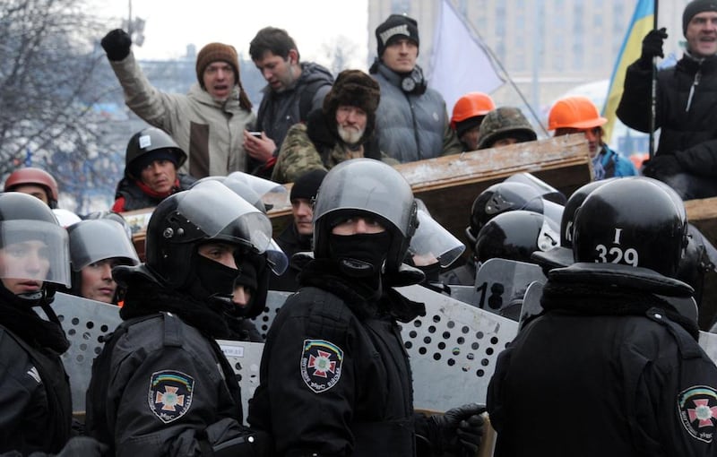 Anti-Yanukovych protesters defend their barricades in front of anti-riot police on Independence Square in Kiev. Viktor Drachev / AFP