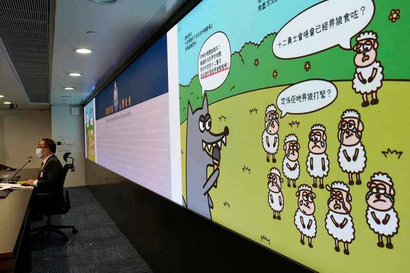 Li Kwai-wah, senior superintendent of Hong Kong's Police National Security Department, speaks in front of a screen showing illustrations from children's books that officials said promoted sedition. AP