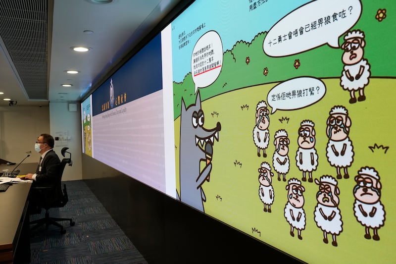 Li Kwai-wah, senior superintendent of Hong Kong's Police National Security Department, speaks in front of a screen showing illustrations from children's books that officials said promoted sedition. AP