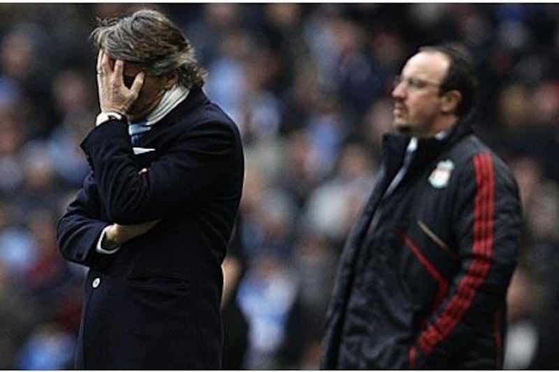 Manchester City's manager Roberto Mancini, left, is seen alongside Liverpool manager Rafael Benitez during a frustrating afternoon for both managers at Eastlands.