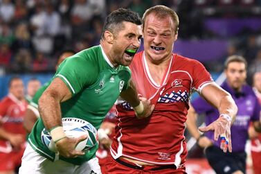 Rob Kearney, who scorted Ireland's first try on Thursday, attempts to hold off the attentions of Russia's Denis Simplikevich in Kobe. Reuters