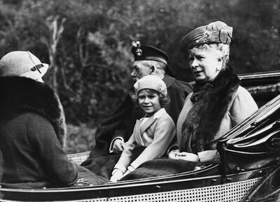 The queen, then Princess Elizabeth, seated between her grandfather King George V and grandmother Queen Mary of Teck as they ride in a carriage to Balmoral Castle in August 1935. Photo: Hulton Archive