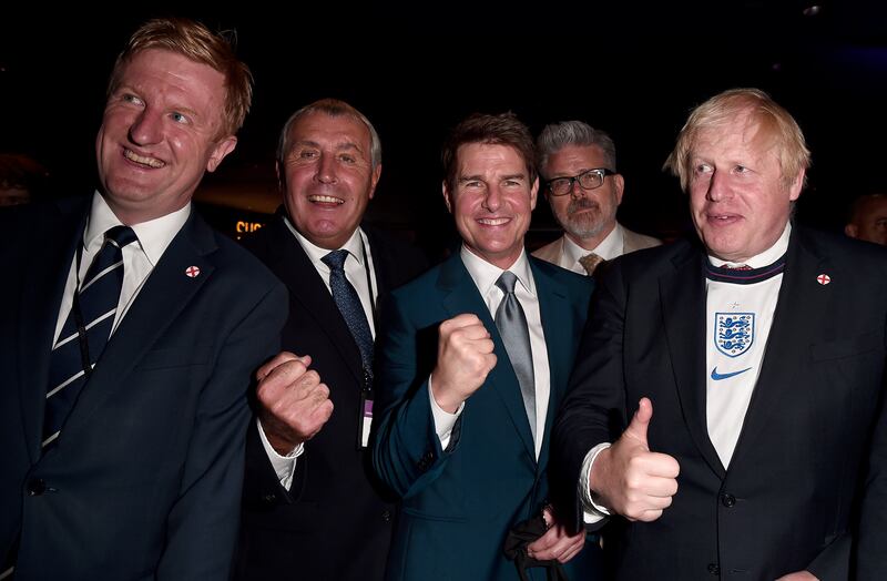 Oliver Dowden, Secretary of State for Digital, Culture, Media and Sport of the UK, Peter Shilton, former England international, actor Tom Cruise, director Christopher McQuarrie and UK Prime Minister Boris Johnson pose for a photograph.