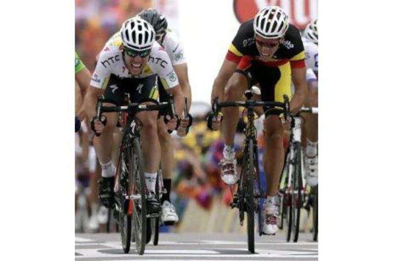 Mark Cavendish, left, reacts to the challenge of Philippe Gilbert, right, during the final sprint in the fifth stage of the Tour de France from Carhaix to Cap Frehel. Cavendish held him off to win the stage.