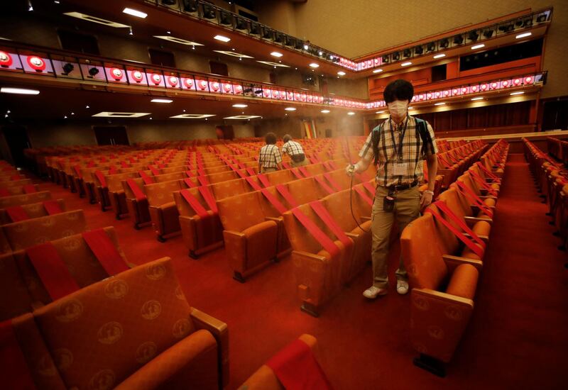 Workers wearing protective face masks disinfect seats at the Kabukiza Theatre, where Japan's stately traditional Kabuki theatre will resume on August 1 following a five-month closure due to the coronavirus disease (COVID-19) outbreak, in Tokyo, Japan July 31, 2020. Picture taken July 31, 2020. REUTERS/Issei Kato