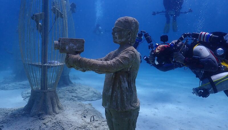 A diver swims near a sculpture during the inauguration of the Ayia Napa Underwater Sculpture Museum in Cyprus.