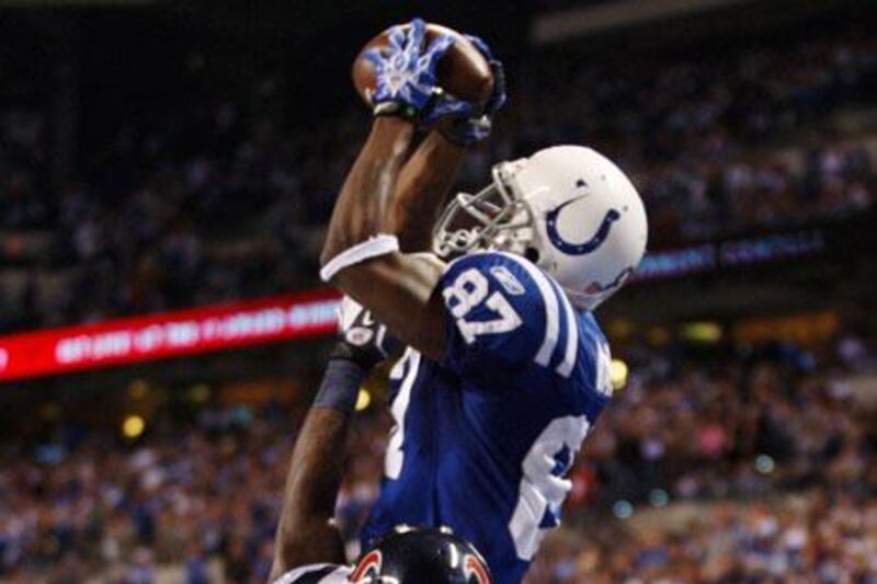 Reggie Wayne goes up and over to catch a touchdown pass with just 19 seconds left on the clock against the Texans. Wayne had said before the game that he wanted to go out on a high.