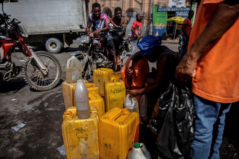 A woman sells petrol in Port-au-Prince. AFP