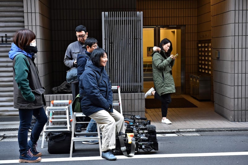 Members of the media wait outside an entrance to the offices of the Japanese lawyers for former Nissan chief Carlos Ghosn in Tokyo. AFP
