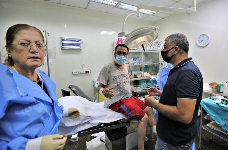 epa08584091 A man injured in the Beirut Port explosion receives treatment at Najjar Hospital in Al-Hamra area in Beirut, Lebanon, 04 August 2020. According to media reports citing official sources at least 40 people were killed and 2,500 injured in the explosion which also caused severe damage, while its cause is not yet known.  EPA/NABIL MOUNZER