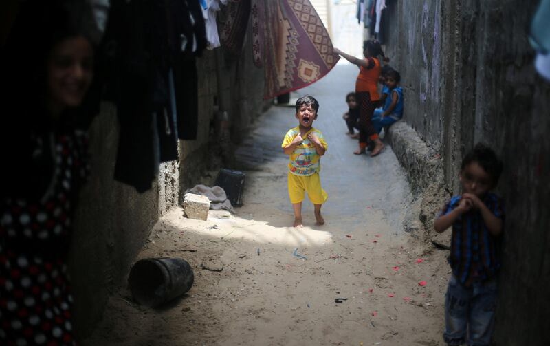 A Palestinian boy cries outside his family's house in Khan Younis refugee camp in the southern Gaza Strip, July 11, 2017. Ibraheem Abu Mustafa / Reuters