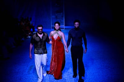 Sandhu presenting a creation by designers Shivan and Narresh during the Lakme Fashion Week in New Delhi in March 2022. AFP
