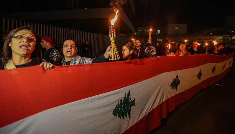 epa07339338 Lebanese activists from the civil society shout slogans, hold placards and Lebanese flags during a protest infront the T.V.A office in Beirut, Lebanon, 02 Februay 2019. Hundreds of Lebanese activists from the civil society shout slogans as they protest against the bad living situations in Lebanon, and rejecting the unfair taxes on gasoline and value added tax (VAT) and all indirect taxes, calling on the government to protect citizens, right to work, right to have access to free medical care, and rehabilitation of the governmental hospitals like the private hospitals.  EPA/NABIL MOUNZER