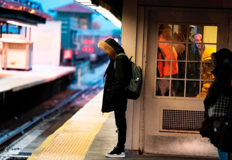 A young man waits on a subway platform in freezing temperatures in New York. AFP